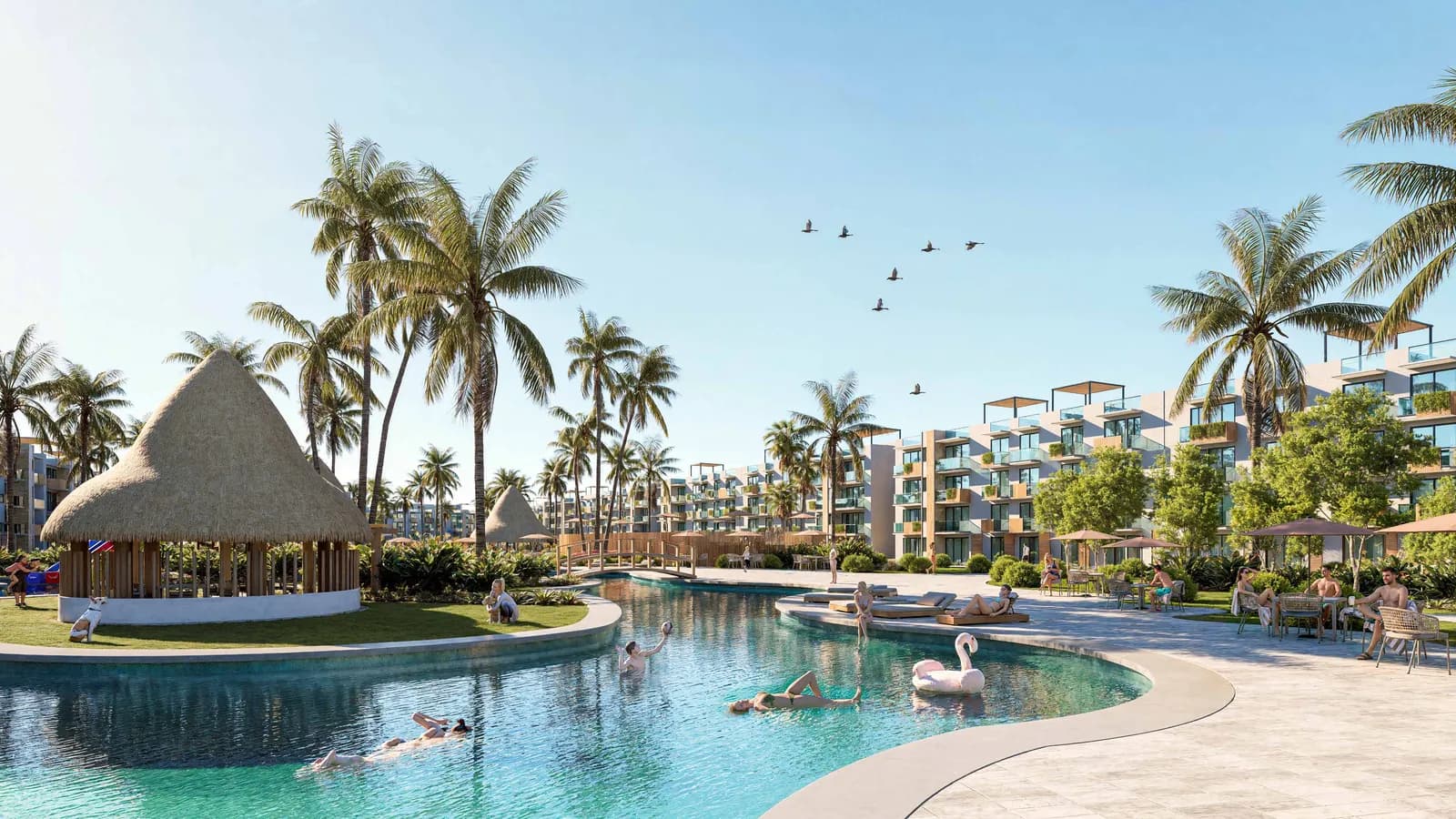 Piscine lagon d'AURA Boulevard avec palapa et immeubles entourés de palmiers