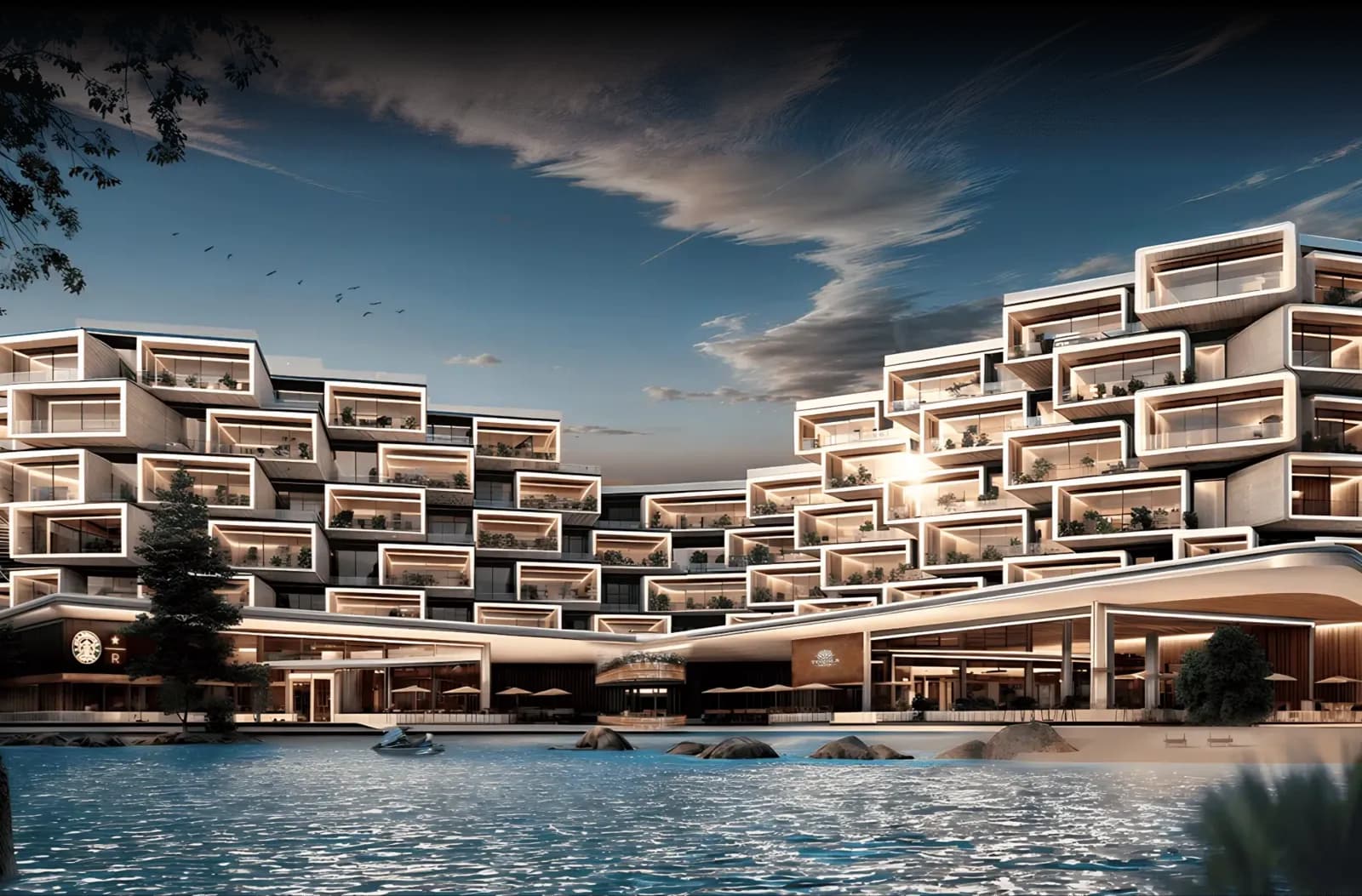 Façade illuminée de Makai Residences au crépuscule, au bord d'un plan d'eau à Cap Cana