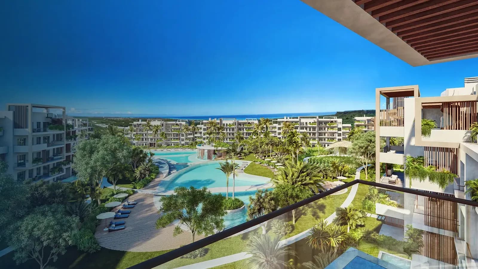 Vue d'un balcon sur les piscines et jardins de The Seed, mer à l'horizon
